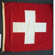 Flag of Switzerland from Bathyscaph TriesteAuguste Piccard explored the stratosphere and set an altitude record of 15,781 metres with his gas balloon in 1931. With the submarine “Trieste” designed by him, his son Jacques and Don Walsh reached the record depth of 10,916 m beneath the surface of the sea in 1960. The bathyscaph is essentially a type of underwater balloon: the large float chamber was filled with petrol because it is lighter than water. The pilots were located in the pressure sphere below the float chamber. At the deepest point, the surface of the sphere was subjected to a pressure in excess of 170,000 tonnes.Shortly before the “Trieste’s” legendary dive into the Marianas Trench, the Americans demanded that the research project be restricted to their own nationals and only flew the American flag. However, because of a written agreement and on account of his great experience, Jacques Piccard remained the captain in charge. He placed his Swiss flag well below the pilots’ seats, thereby ensuring that our national emblem had the honour of being even deeper on the sea bed than the two pilots.